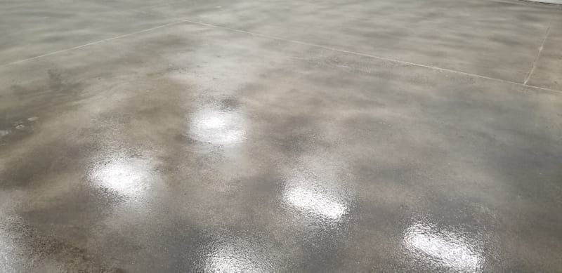 Polished smooth concrete surface with light reflections showing the troweled finish