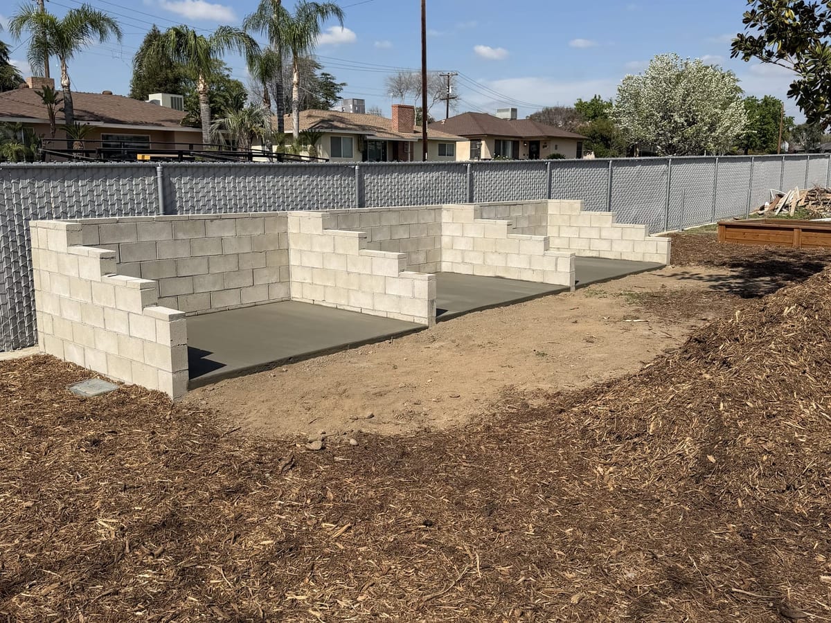 Cinder block forming walls set up for a pool deck pour, ready for concrete placement